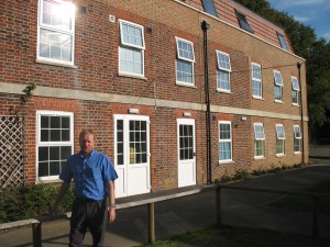 CEO Mike Penny outside refurbished McMillan house