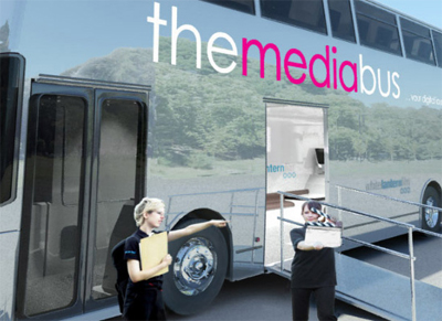 mediabus1 A double decker bus with two girls standing in front of it